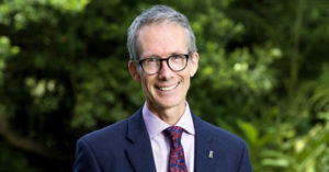 Profile Picture of Prof. Tim Entwisle in a suit with green garden in background