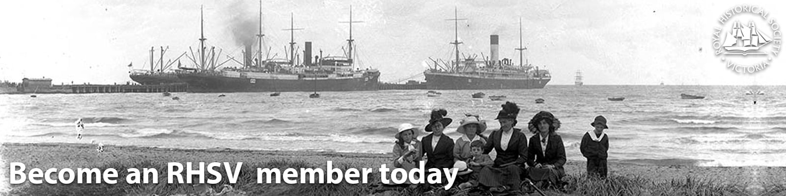 Historic black and white photograph of a beach scene with two large steamships in the background on the water. In the foreground, several women and a child are seated on the shoreline wearing early 20th century clothing and hats. Text at the bottom reads "Become an RHSV member today" with the RHSV logo in the top right corner.